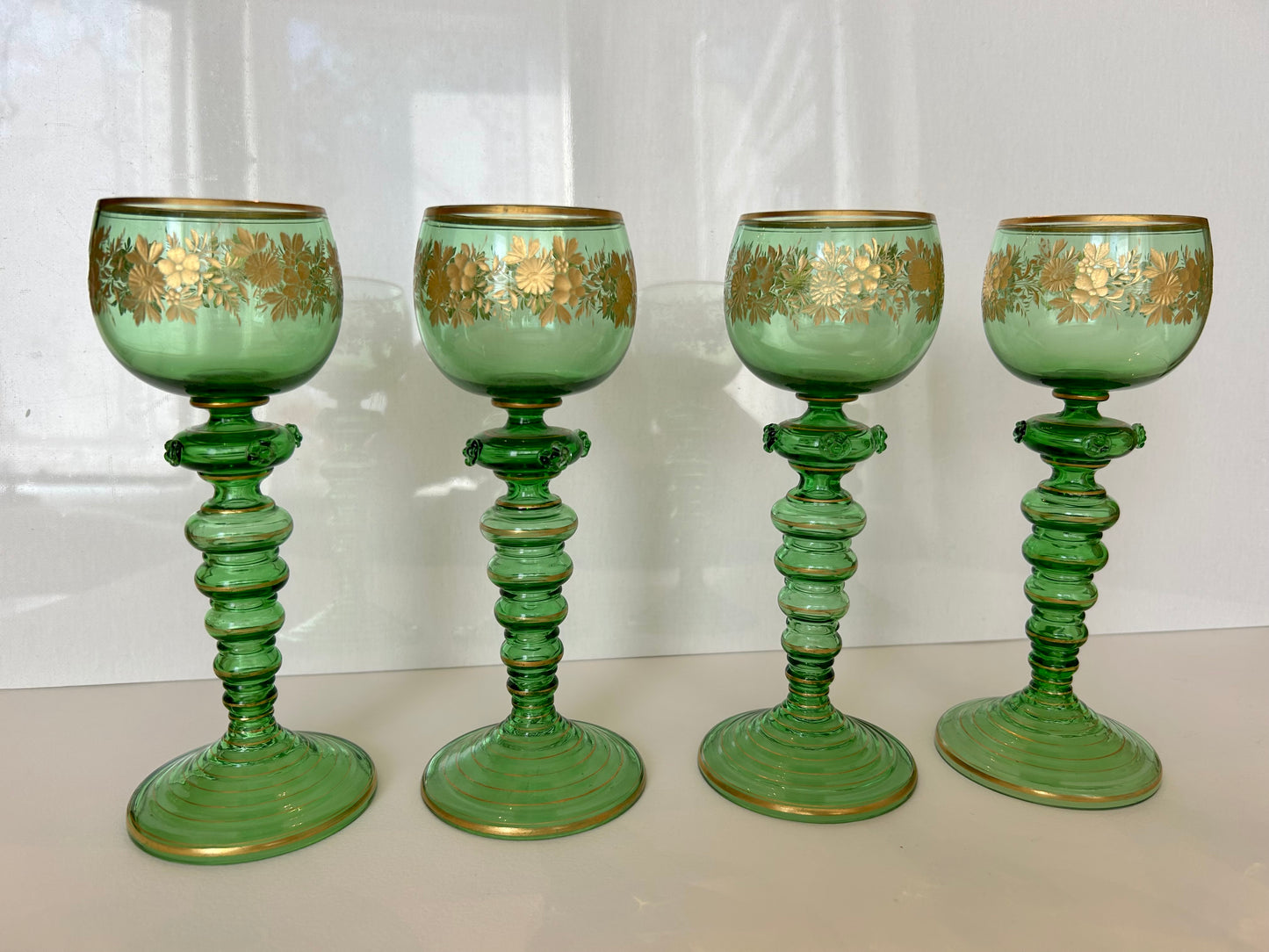 Four Continental Engraved and Gilt Green Glass Roemers, c.1900